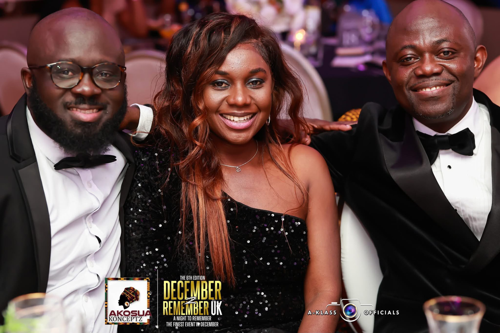 Three guests in black tie and a black sequinned dress posing together