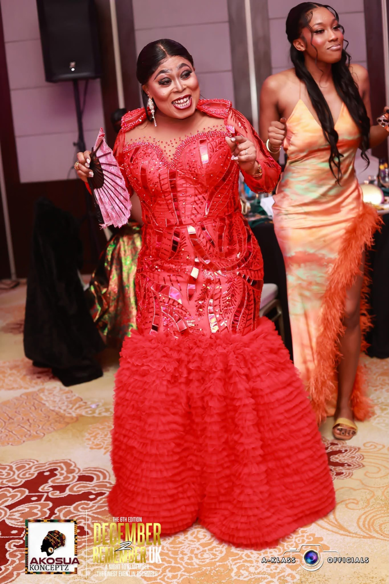 Guest in a floor-length red sequinned gown at December To Remember UK