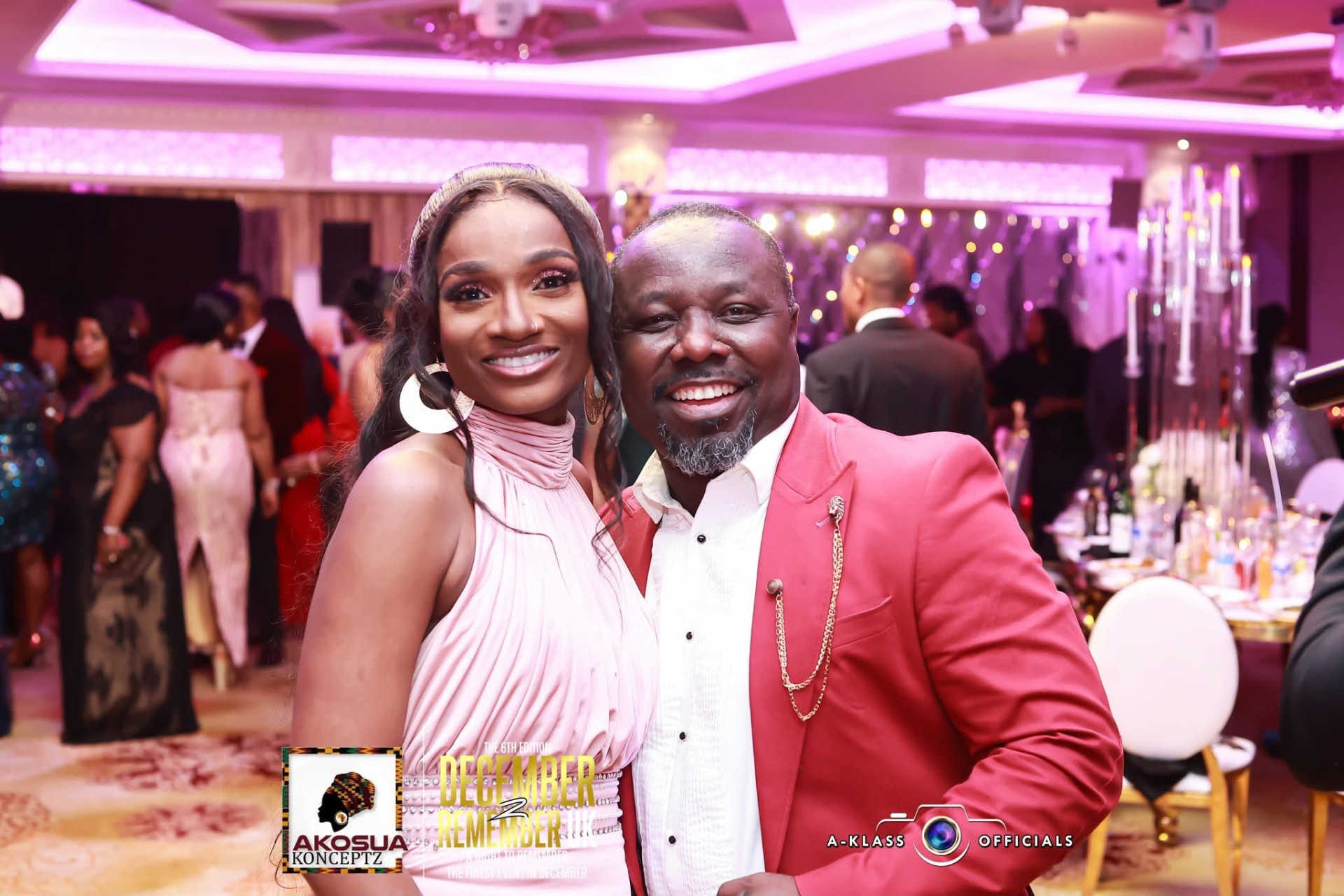 Guests in a red dinner jacket and blush gown at their table